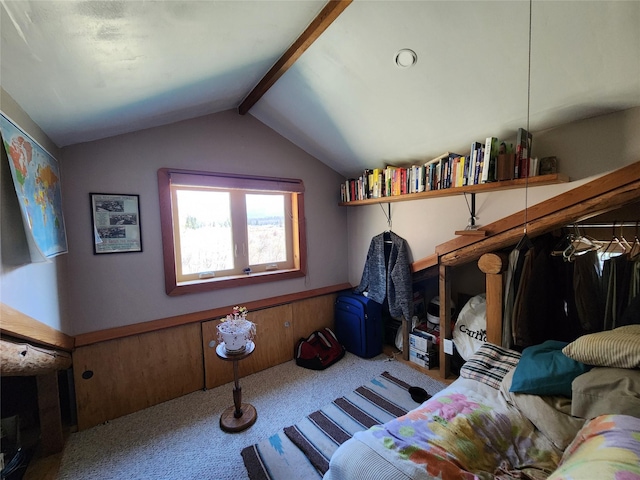 interior space with carpet flooring and vaulted ceiling with beams