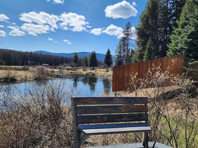 view of water feature with a mountain view and fence