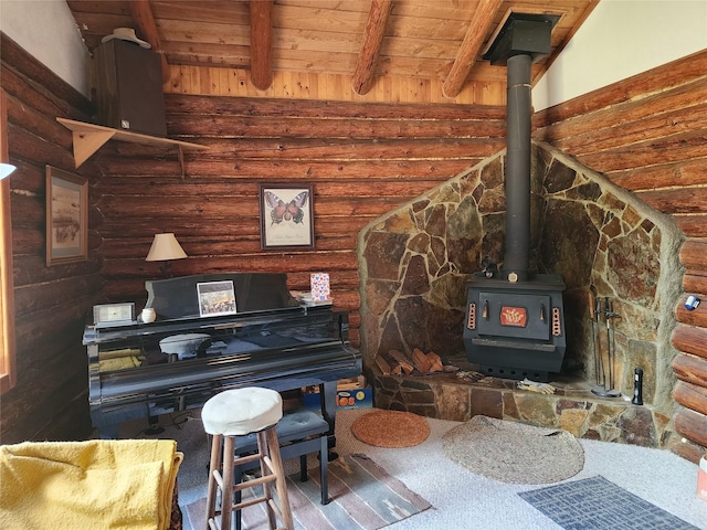 sitting room with wood finished floors, a wood stove, wooden ceiling, beamed ceiling, and rustic walls