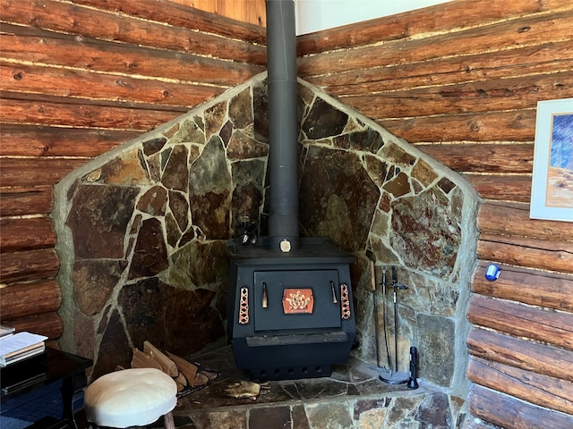 details with a wood stove and rustic walls