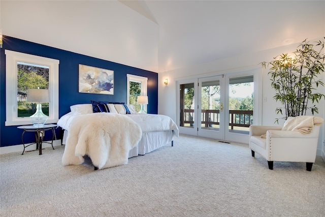 carpeted bedroom with visible vents, access to exterior, and high vaulted ceiling