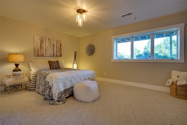 bedroom featuring carpet floors, baseboards, and visible vents