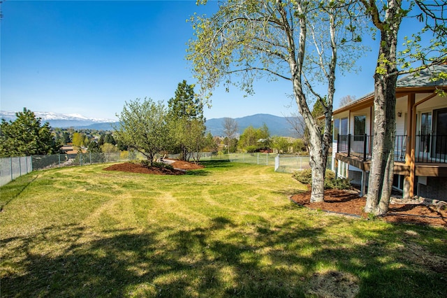 view of yard with a fenced backyard and a mountain view