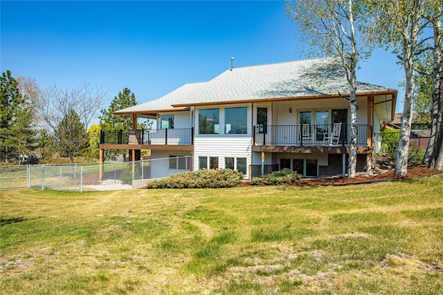 back of house with a yard, fence, and a balcony