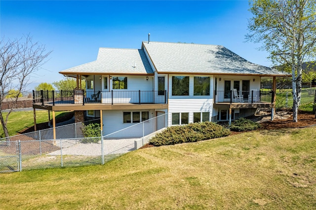 back of property featuring a lawn, a fenced backyard, and a balcony