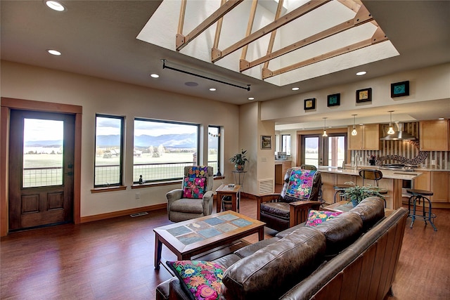 living area with baseboards, visible vents, recessed lighting, and wood finished floors