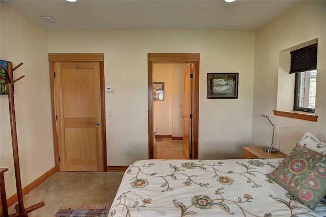 bedroom featuring light colored carpet and baseboards