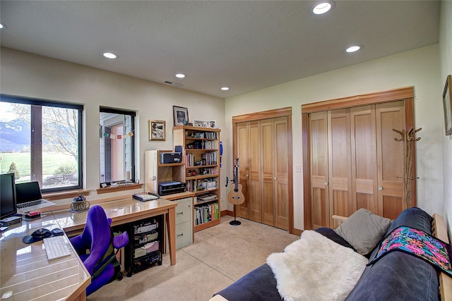 office space featuring recessed lighting, visible vents, and light colored carpet