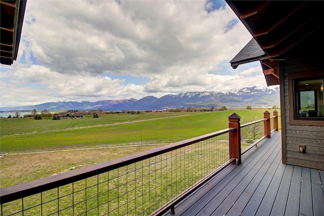 deck featuring a yard, a rural view, and a mountain view