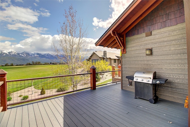 wooden terrace featuring a mountain view and a grill