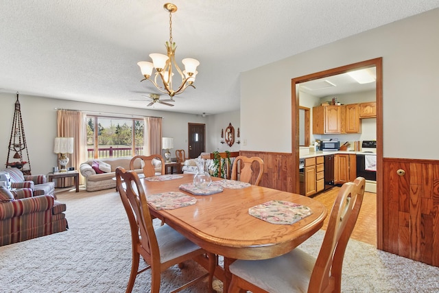 dining space with light colored carpet, wooden walls, and a wainscoted wall
