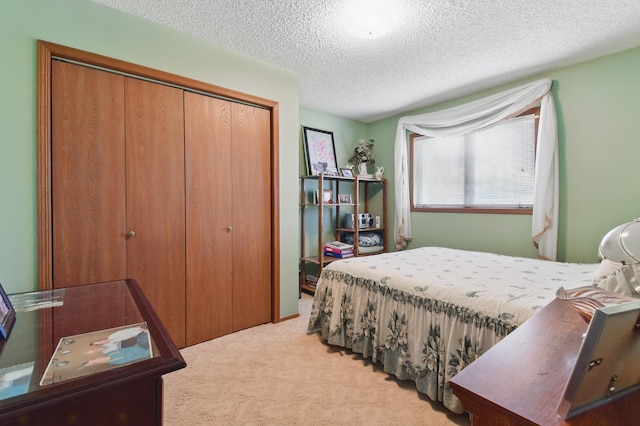 carpeted bedroom featuring a closet and a textured ceiling