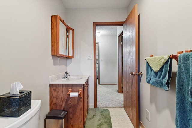 bathroom with tile patterned floors, toilet, and vanity