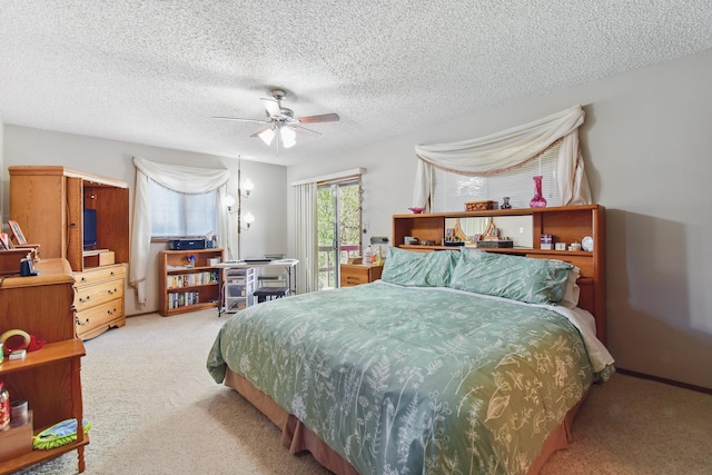 bedroom featuring carpet, a ceiling fan, access to exterior, and a textured ceiling
