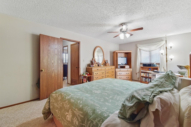 bedroom featuring a textured ceiling, carpet flooring, baseboards, and a ceiling fan