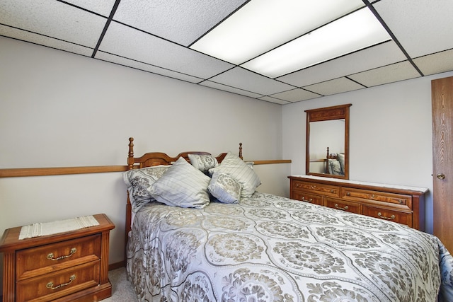 carpeted bedroom with a paneled ceiling
