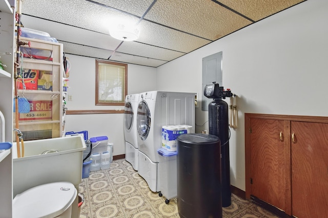 clothes washing area with separate washer and dryer, laundry area, baseboards, and tile patterned floors