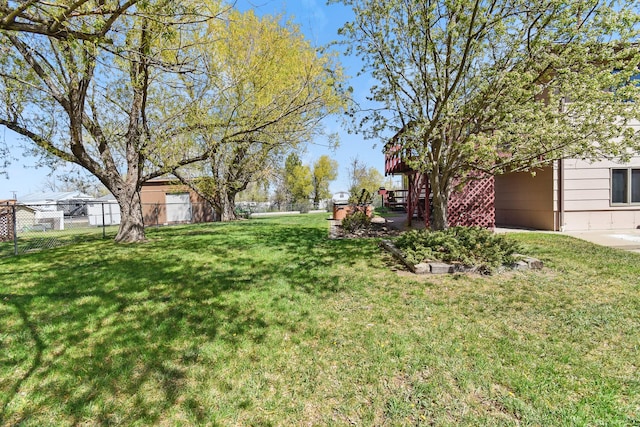 view of yard with fence and stairs