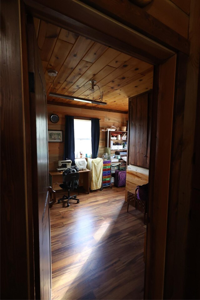 office space with wooden ceiling, wood walls, and wood finished floors