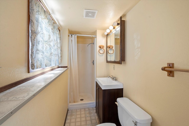 1108 9th St E, Polson, MT 59860 - full bath with toilet, vanity, a shower with curtain, and tile patterned floors