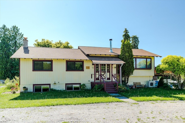 1108 9th St E, Polson, MT 59860 - view of front of property featuring a front yard, a chimney, a cooling unit, and roof with shingles