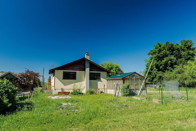 1108 9th St E, Polson, MT 59860 - back of house with an exterior structure, a chimney, and an outdoor structure