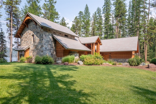 view of front of house with stone siding and a front yard