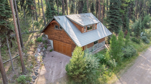 144 S Shore Pl, Seeley Lake, MT 59868 - garage with a view of trees, a garage, and dirt driveway
