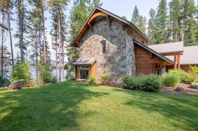 144 S Shore Pl, Seeley Lake, MT 59868 - view of property exterior featuring stone siding and a yard