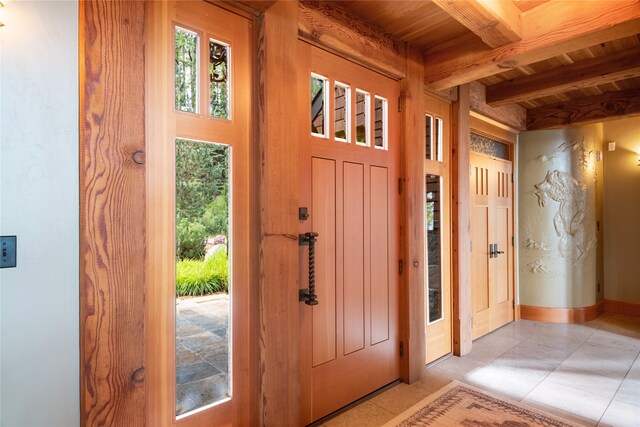 144 S Shore Pl, Seeley Lake, MT 59868 - entrance foyer featuring a wood ceiling with exposed beams and light tile patterned floors