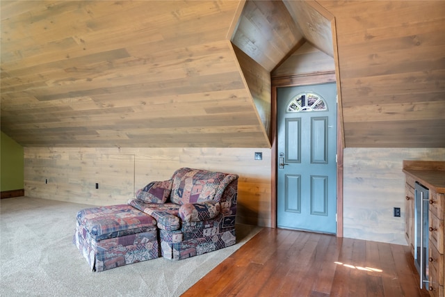 144 S Shore Pl, Seeley Lake, MT 59868 - living area featuring wooden walls, vaulted ceiling, wood ceiling, and hardwood / wood-style floors