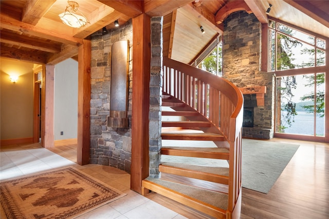 144 S Shore Pl, Seeley Lake, MT 59868 - stairway featuring wooden ceiling, healthy amount of natural light, tile patterned floors, and a stone fireplace