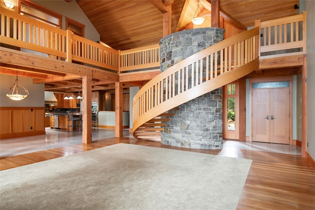 144 S Shore Pl, Seeley Lake, MT 59868 - unfurnished living room with high vaulted ceiling, a wooden ceiling with exposed beams, wood finished floors, and stairway