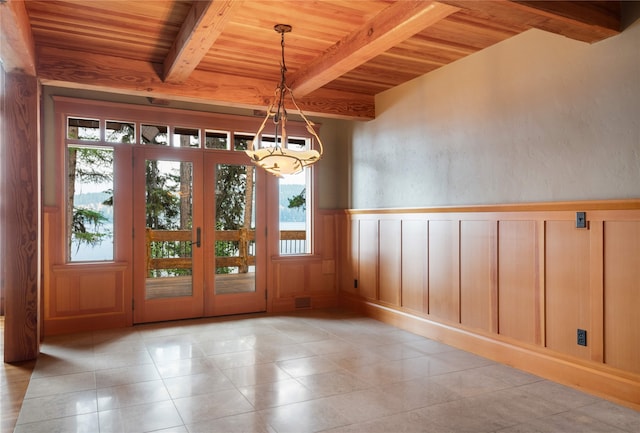144 S Shore Pl, Seeley Lake, MT 59868 - interior space with a wood ceiling with exposed beams, a chandelier, plenty of natural light, light tile patterned floors, and wainscoting