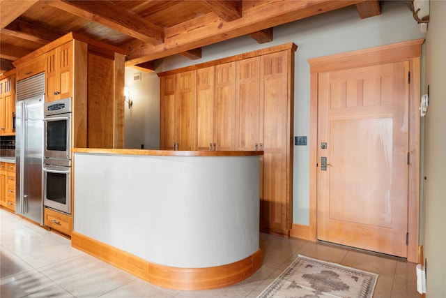 144 S Shore Pl, Seeley Lake, MT 59868 - kitchen featuring a wood ceiling with exposed beams, appliances with stainless steel finishes, light tile patterned flooring, and backsplash