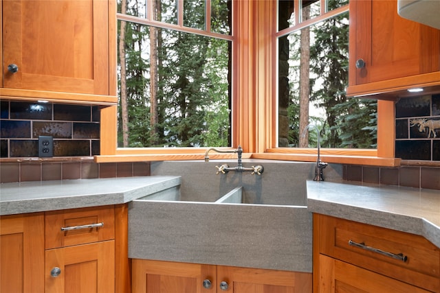 144 S Shore Pl, Seeley Lake, MT 59868 - kitchen with backsplash, plenty of natural light, and brown cabinetry