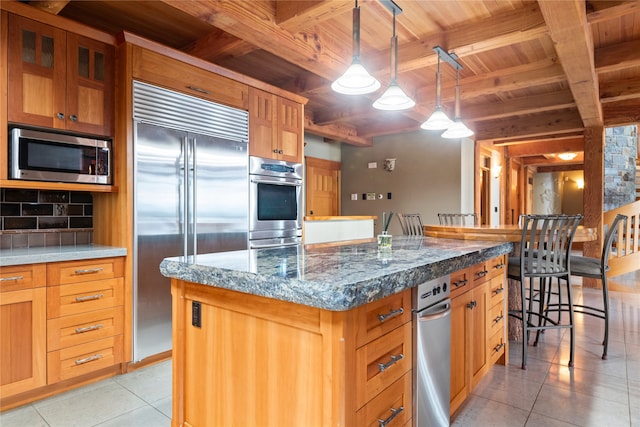 144 S Shore Pl, Seeley Lake, MT 59868 - kitchen featuring stainless steel appliances, a wooden ceiling with exposed beams, light tile patterned floors, a center island, and pendant lighting