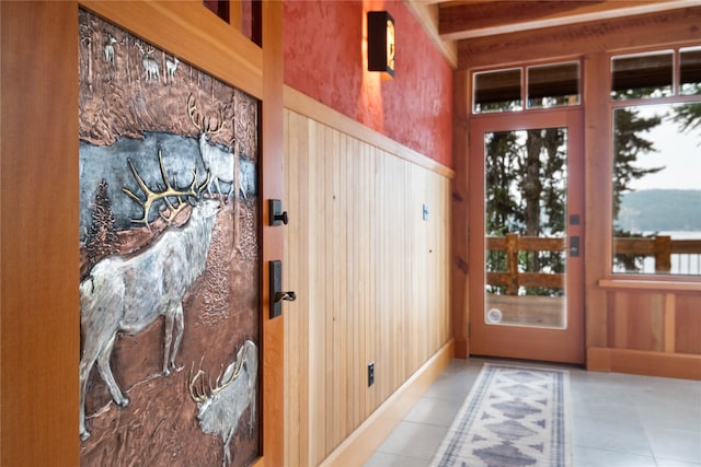 144 S Shore Pl, Seeley Lake, MT 59868 - doorway featuring tile patterned floors and wood walls
