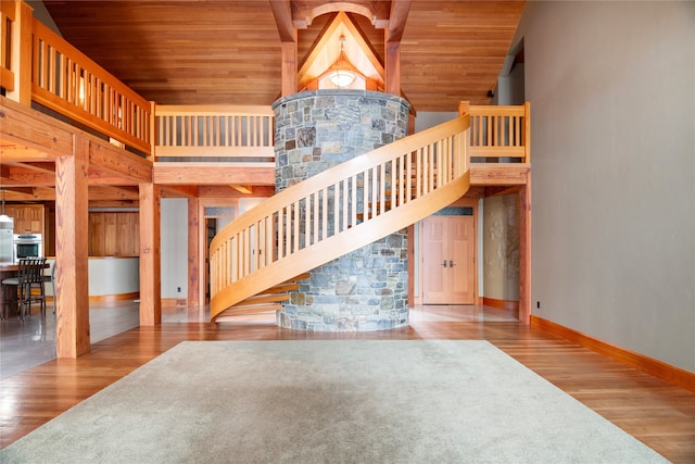 144 S Shore Pl, Seeley Lake, MT 59868 - staircase featuring wood finished floors, wooden ceiling, and a towering ceiling
