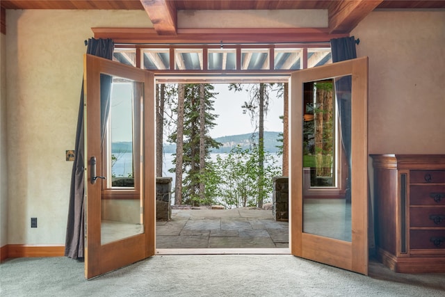 144 S Shore Pl, Seeley Lake, MT 59868 - doorway with carpet floors, a wooden ceiling with exposed beams, french doors, and a mountain view