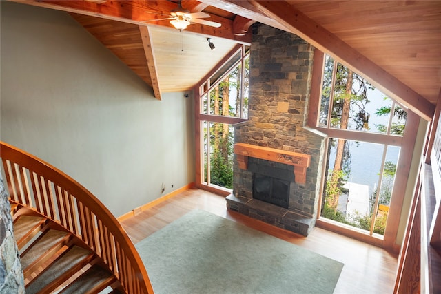 144 S Shore Pl, Seeley Lake, MT 59868 - unfurnished living room with wood ceiling, ceiling fan, wood finished floors, a fireplace, and stairs