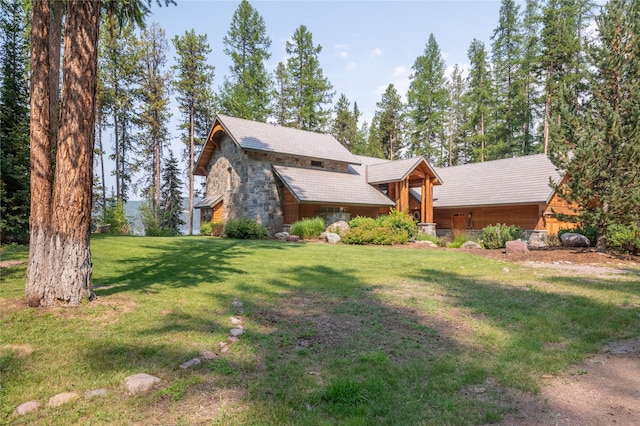 144 S Shore Pl, Seeley Lake, MT 59868 - view of front of house featuring stone siding and a front lawn