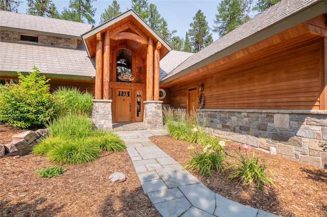 144 S Shore Pl, Seeley Lake, MT 59868 - property entrance with stone siding and a shingled roof