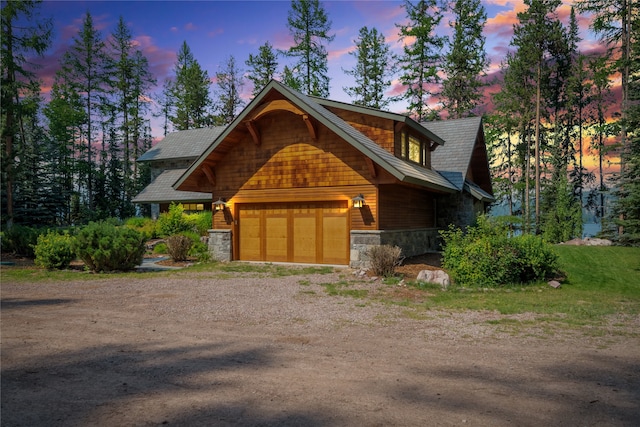 144 S Shore Pl, Seeley Lake, MT 59868 - log home featuring stone siding, dirt driveway, and a garage