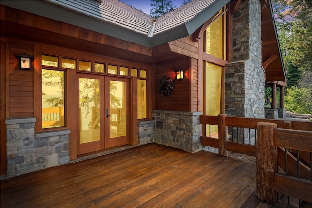 144 S Shore Pl, Seeley Lake, MT 59868 - property entrance with stone siding, french doors, and a wooden deck