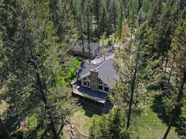 birds eye view of property with a wooded view