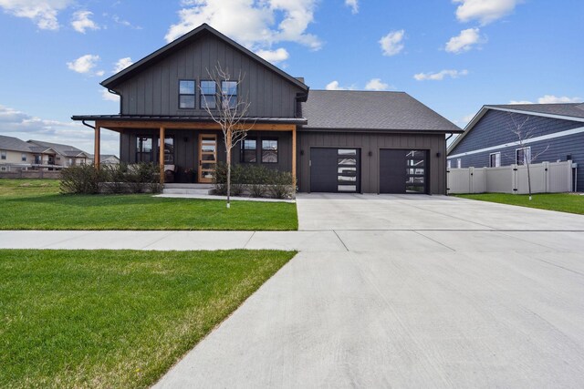 128 Owl Loop, Kalispell, MT 59901 - modern inspired farmhouse with driveway, a garage, board and batten siding, and a porch