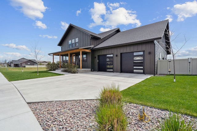 128 Owl Loop, Kalispell, MT 59901 - modern farmhouse style home with a gate, board and batten siding, concrete driveway, a porch, and an attached garage