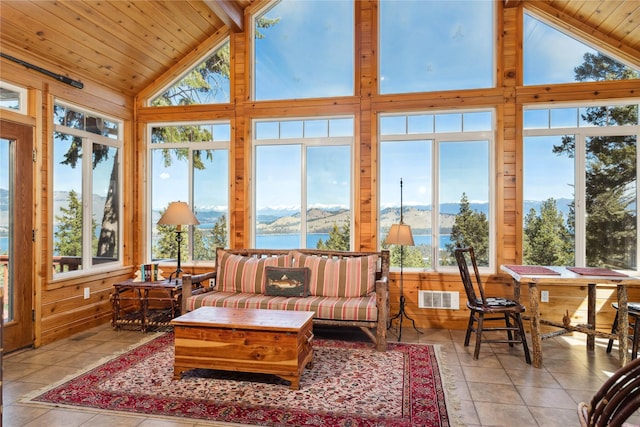 42746 Knuppel Ln, Big Arm, MT 59910 - sunroom / solarium featuring healthy amount of natural light, wooden ceiling, a water and mountain view, high vaulted ceiling, and wooden walls
