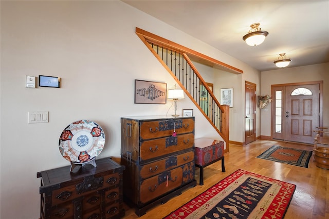 42746 Knuppel Ln, Big Arm, MT 59910 - foyer entrance with stairs, wood finished floors, and baseboards